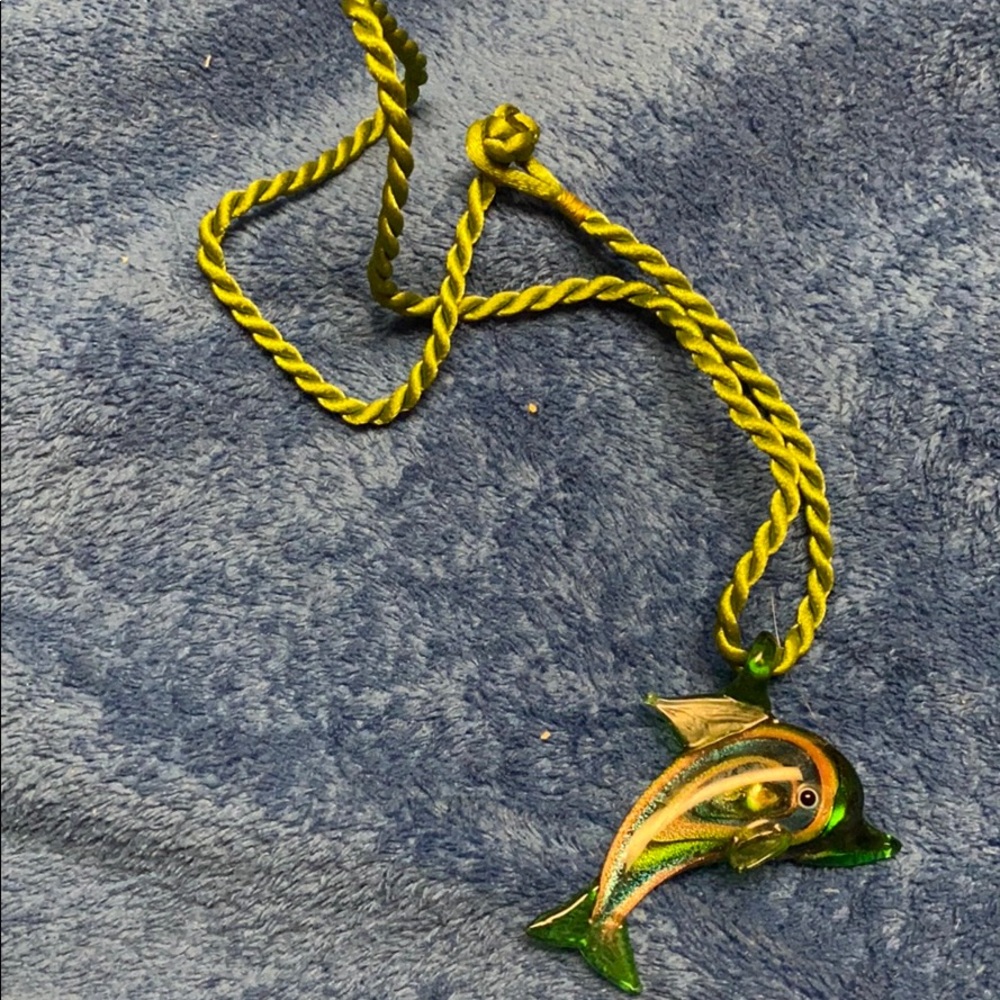 A glass dolphin necklace